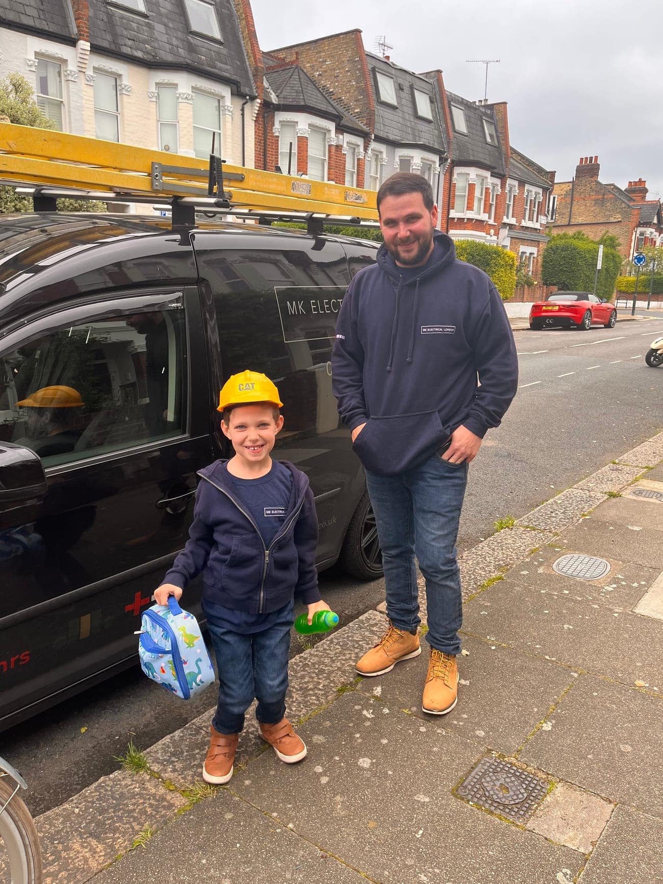 Martin and his son Zak in front of the MK Electrical London van in Fulham