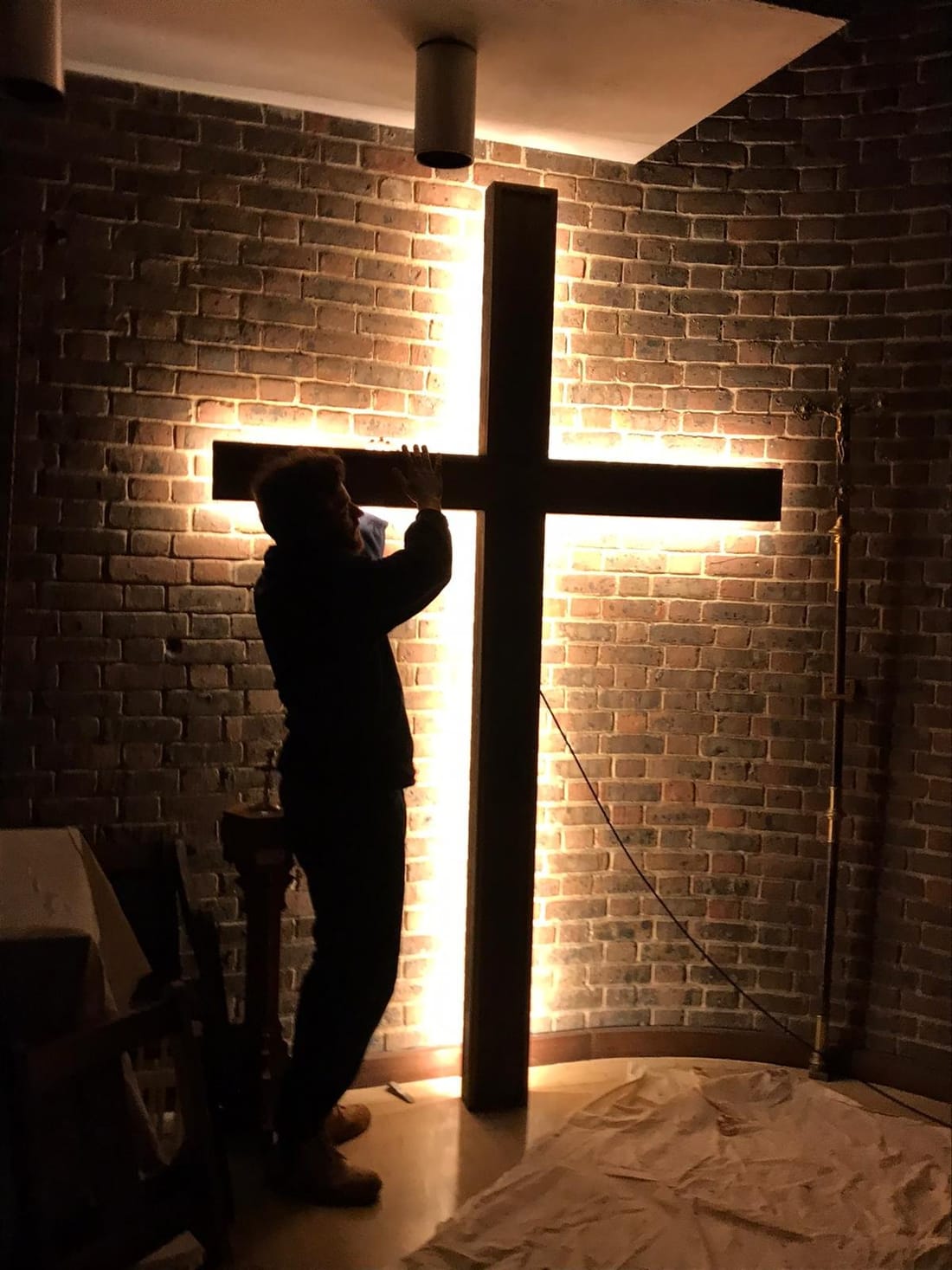 Backlit cross installation by MK Electrical London — brightness controlled by the dimmer